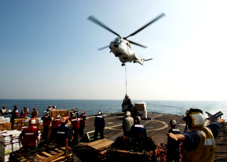 US Navy 041112-N-4374S-013 Sailors assigned to the guided missile cruiser USS Vicksburg (CG 69) receive pallets of stores from an SA-330 Puma helicopter
