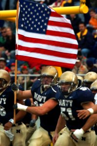 US Navy 041120-N-9693M-001 U.S. Naval Academy Midshipman 1st Class Tyson Stahl leads the Navy football team onto the field prior to the start of a regular season game against Rutgers University