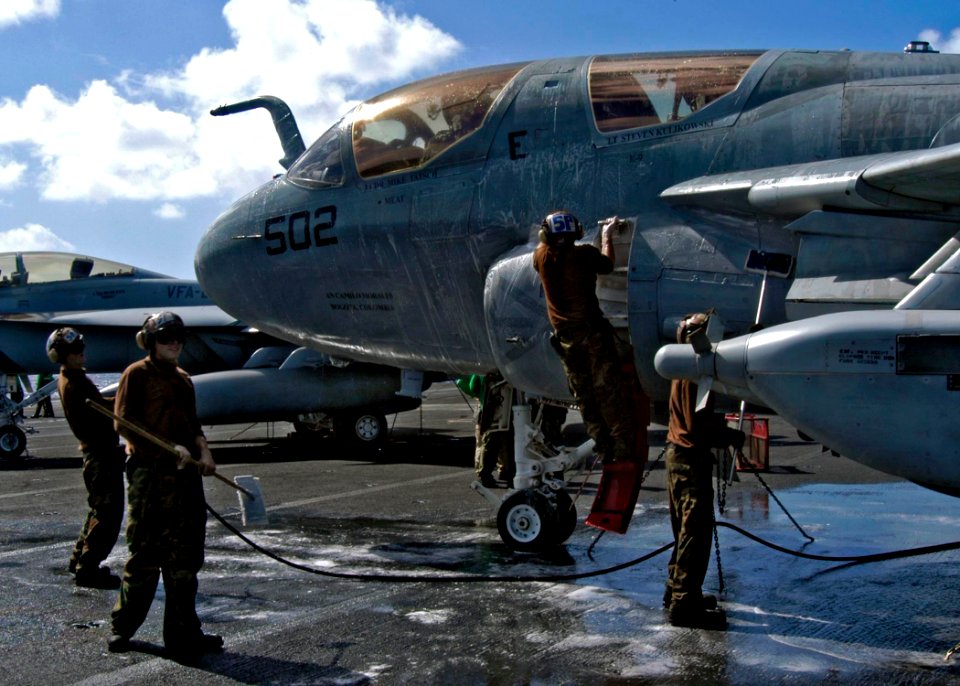 US Navy 041202-N-7816R-001 Sailors scrub-down an EA-6B Prowler during a no-fly day on the flight deck aboard the Nimitz-class aircraft carrier USS Abraham Lincoln (CVN 72)