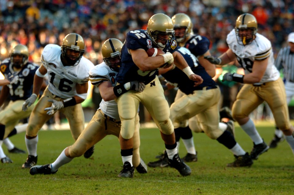 US Navy 041204-N-9693M-012 Navy full back Kyle Eckel breaks through defensive line at 105th Army Navy game