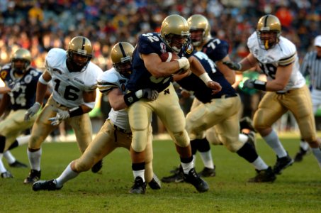 US Navy 041204-N-9693M-012 Navy full back Kyle Eckel breaks through defensive line at 105th Army Navy game
