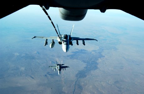 US Navy 041126-F-3188G-141 A pair of F-A-18C Hornets receives fuel from a U.S. Air Force KC-10 Extender photo