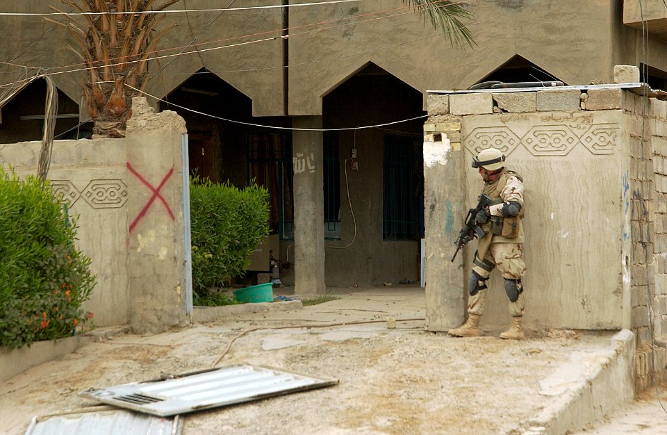 US Navy 041208-N-4614W-008 Master Chief Utilitiesman Pete Sansom secures a perimeter position at a school in Fallujah, Iraq