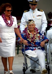 US Navy 041207-N-3019M-004 Mr. Ben Boosinger, a Pearl Harbor survivor, is escorted back to his seat after paying his respects during the 63rd commemoration of the Dec. 7, 1941 attack on Pearl Harbor, Hawaii