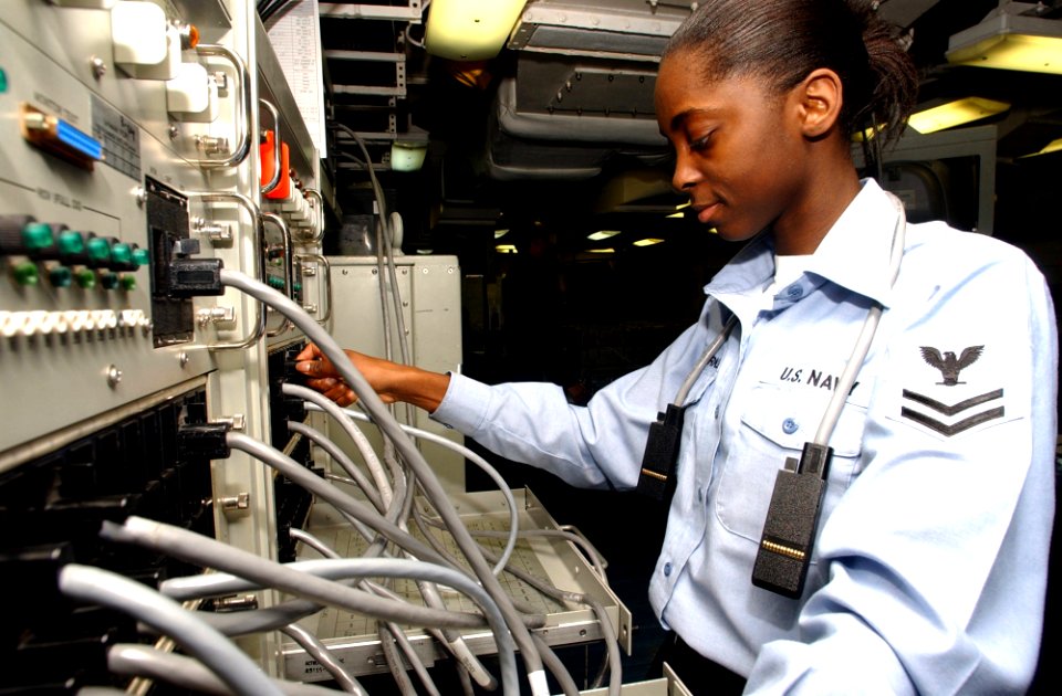 US Navy 041204-N-7405P-073 Information Systems Technician 2nd Class Laresa Buxton makes an adjustment on the Demand Assigned Multiple Access (DAMA) console aboard the Nimitz-class aircraft carrier USS Harry S. Truman (CVN 75)