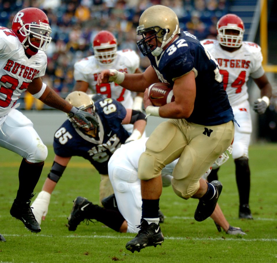 US Navy 041120-N-9693M-009 U.S. Naval Academy Midshipman 1st Class Kyle Eckel breaks through a line of Rutgers University defenders enroute to a touchdown in the 1st quarter