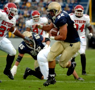 US Navy 041120-N-9693M-009 U.S. Naval Academy Midshipman 1st Class Kyle Eckel breaks through a line of Rutgers University defenders enroute to a touchdown in the 1st quarter