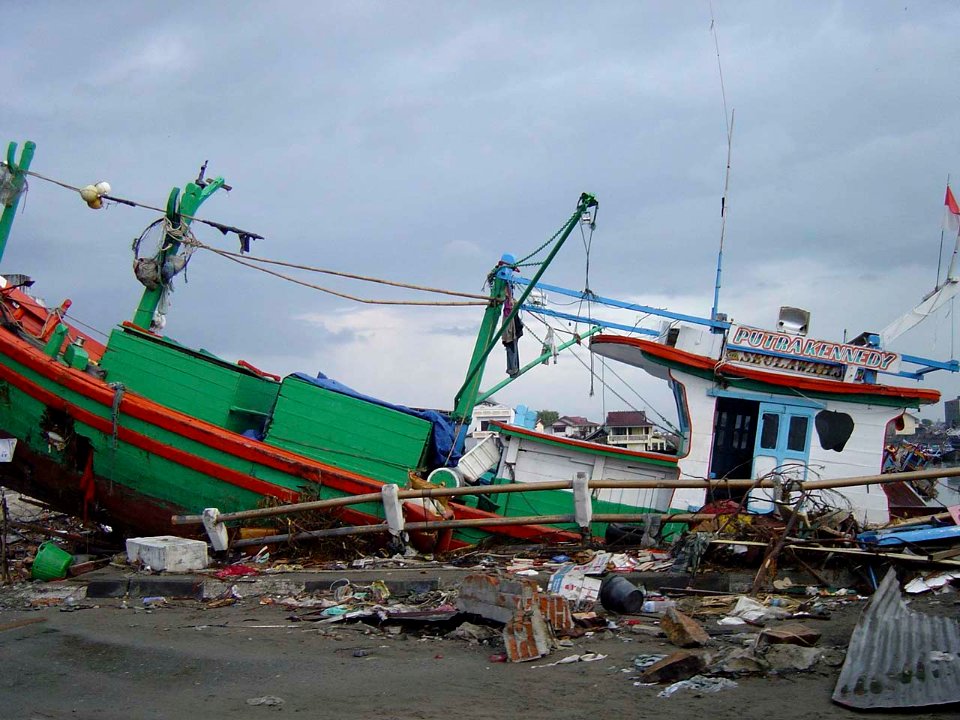 US Navy 050101-O-XXXXB-067 Boats washed ashore near local businesses in down town Aceh, Sumatra following a massive Tsunami that struck the area on the 26th of December 2004