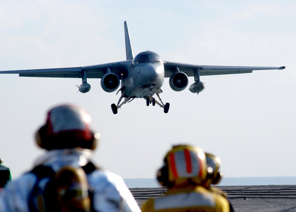 US Navy 041210-N-6363M-006 Flight deck personnel watch as an S-3B Viking assigned to the Checkmates of Sea Control Squadron Two Two (VS-22), makes an approach for an arrested wire landing aboard the Nimitz-class aircraft carrie