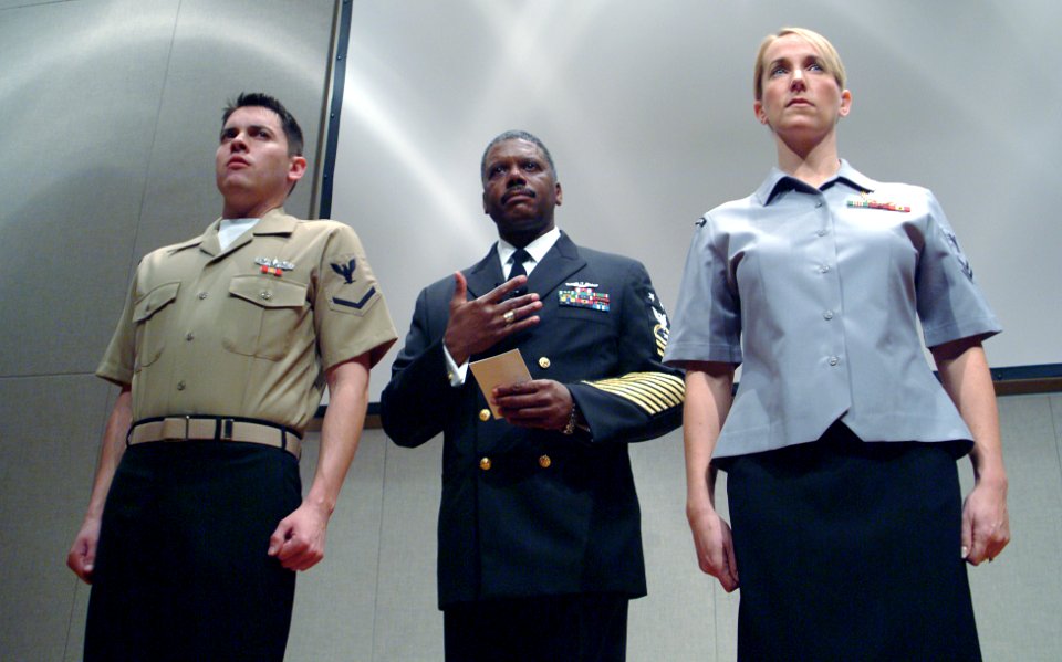 US Navy 041208-N-0962S-009 Chief of Naval Operations-directed Command Master Chief Robert B. Carroll, center, introduces the year-round concept service uniforms for Sailors E-6 and below