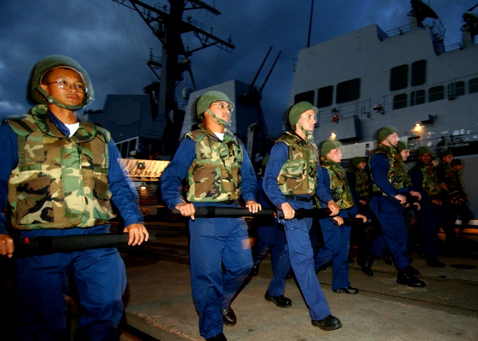 US Navy 041028-N-3019M-006 Sailors aboard the Arleigh Burke-class guided missile destroyer USS Chafee (DDG 90) advance in formation toward an angry crowd during a simulated civil disturbance scenario