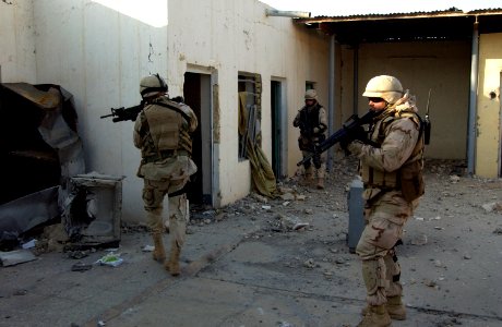 US Navy 041209-N-4614W-028 Navy Reserve Chief Engineering Aide Ardell Ball, right, leads his team of Seabees into a former agricultural building in the city of Fallujah, Iraq