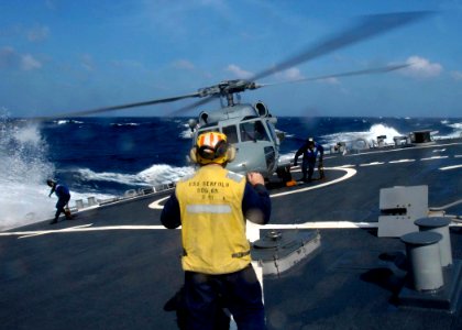 US Navy 050103-N-9079D-412 Sailors work to prepare an MH-60S Knighthawk helicopter for flight as the guided missile destroyer USS Benfold (DDG 65) takes a turn