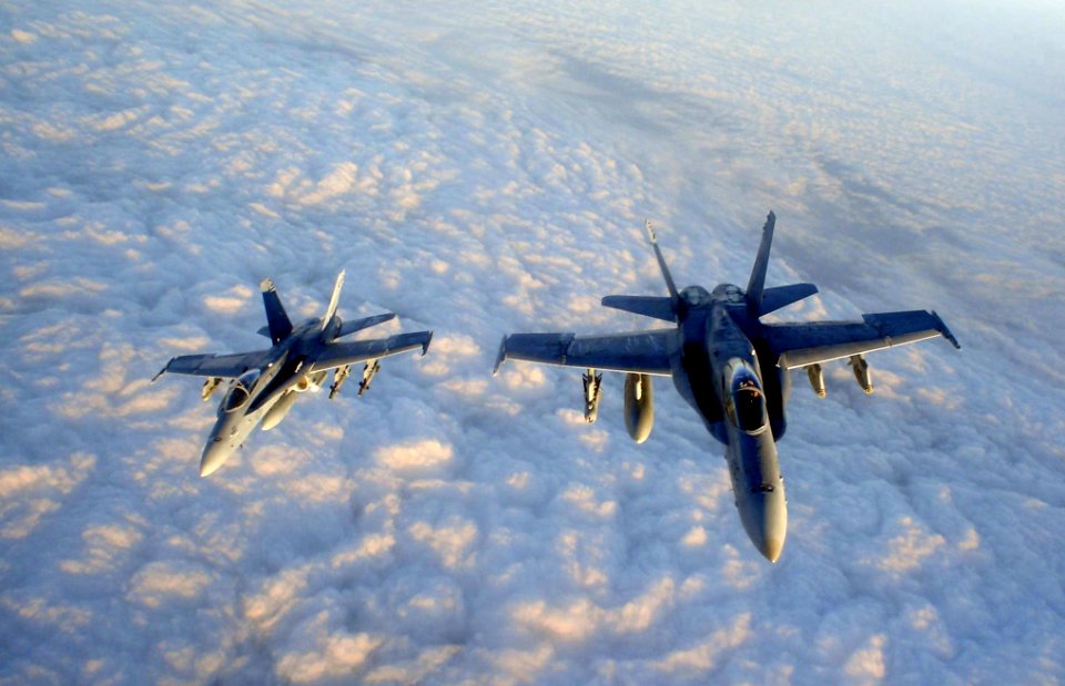 US Navy 041212-N-0000X-003 Two F-A-18C Hornets assigned to the Gunslingers of Strike Fighter Squadron One Zero Five (VFA-105) fly in formation after being refueled by an Air Force KC-130 tanker