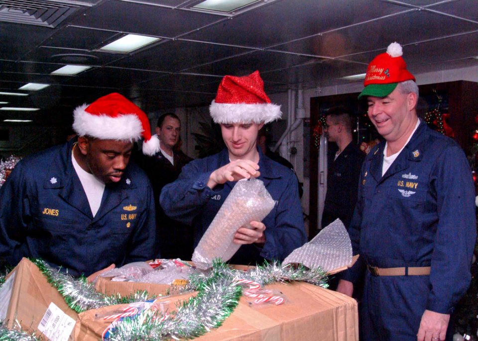 US Navy 041215-N-0168J-001 Amphibious assault ship USS Essex (LHD 2) Executive Officer, Commander Dorian F. Jones, (left), Information Systems Technician Seaman Adam C. Arnold, (center) and Command Master Chief Craig Morey open