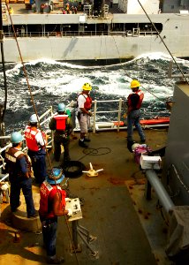 US Navy 050105-N-6074Y-061 Sailors of the Merchant Marine aboard USNS Rainier (T-AOE 7) prepare to receive the fuel transfer line from the USNS Tippecanoe (T-AO 199) as she comes alongside for replenishment