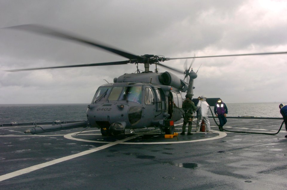 US Navy 041217-F-1740G-005 An Air Force HH-60 Pave Hawk helicopter aboard the amphibious dock landing ship USS Fort McHenry (LSD 43), receives fuel as it completes deck-landing qualification training