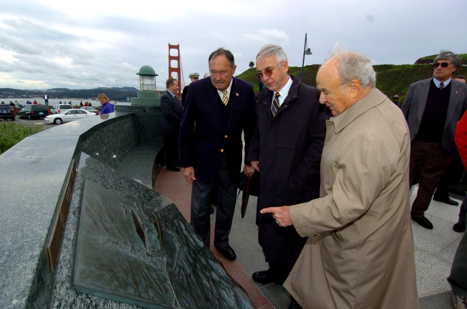 US Navy 041229-N-9693M-253 Secretary of the Navy (SECNAV), Gordon England, center, views the Navy plaque at the Lone Sailor Memorial