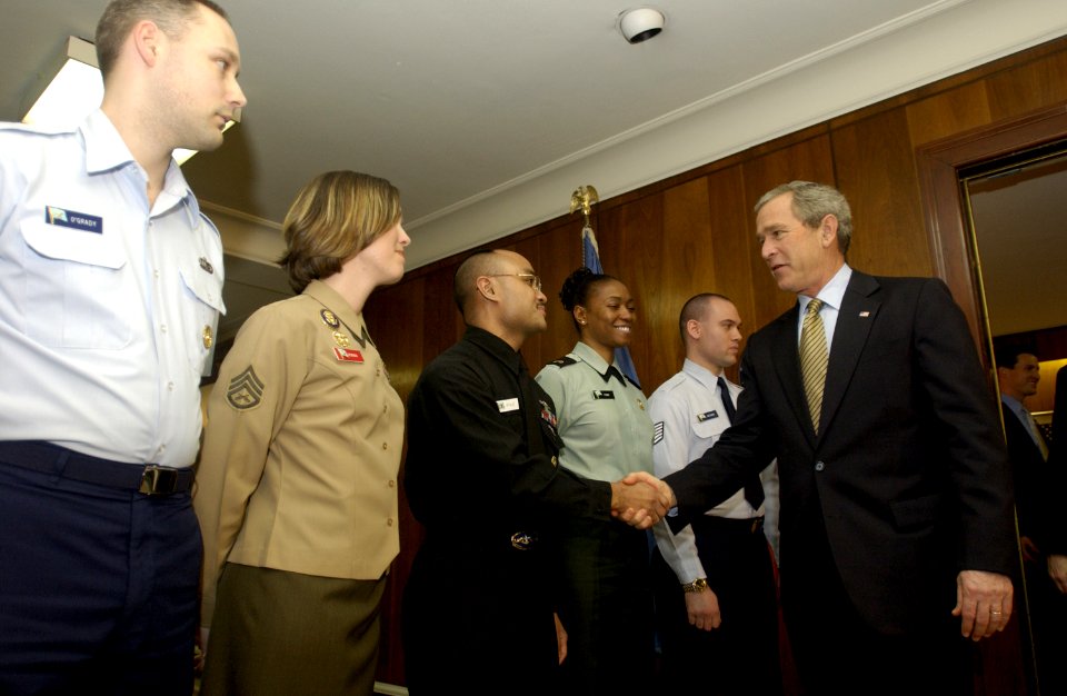 US Navy 050113-F-5586B-061 President George W. Bush shakes hands with Navy Petty Officer 2nd Class George Acffalle, of Guam, during a visit to the Pentagon