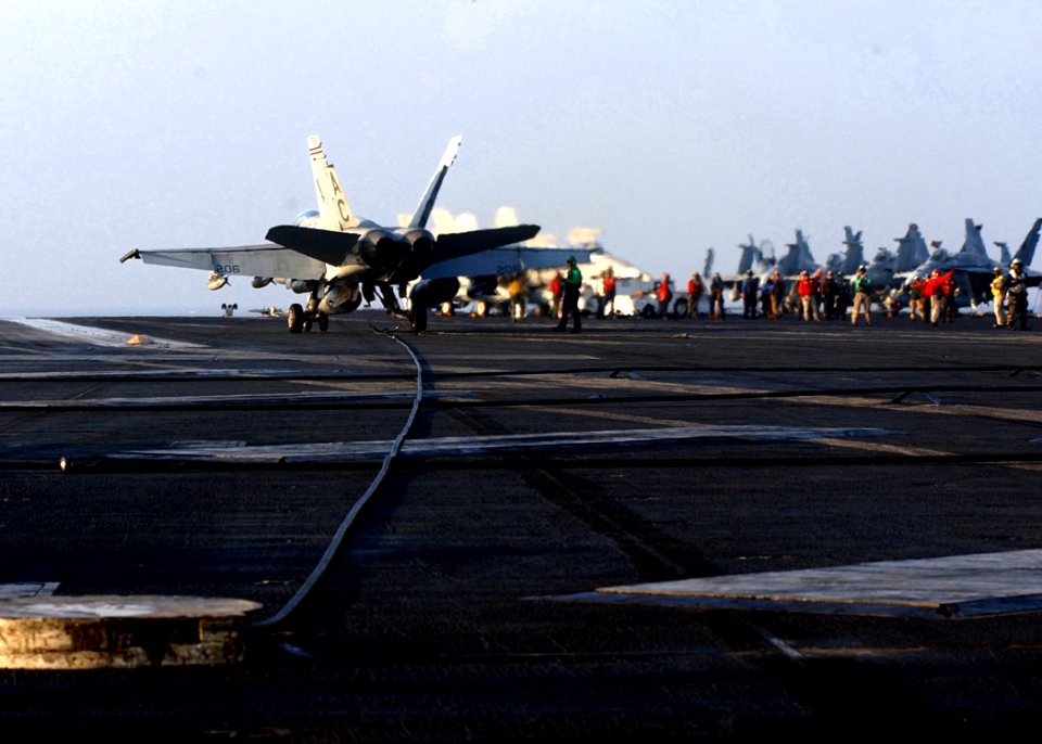 US Navy 041226-N-2984R-084 An F-A-18A- Hornet assigned to Marine Fighter Attack Squadron One One Five (VMFA-115) Silver Eagles catches one of the four arresting wires during aircraft recovery aboard USS Harry S. Truman (CVN 75)