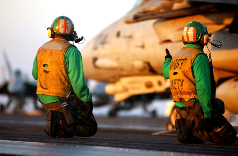 US Navy 050113-N-6363M-023 Aviation Boatswain's Mate 2nd Class Dennis Cochran, left, and Aviation Boatswain's Mate 2nd Class Carry Strome, man the waist catapult safety observer watch