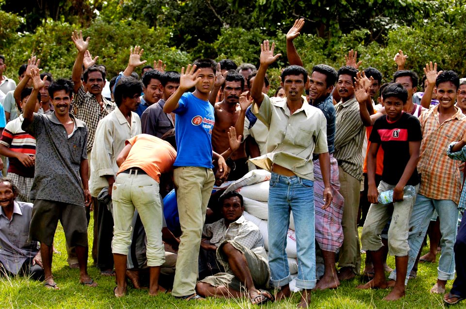 US Navy 050109-N-4166B-158 Indonesian citizens in Tjalang, Sumatra, Indonesia give their thanks for the relief supplies delivered to them by a U.S. Navy Seahawk helicopter