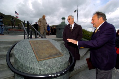 US Navy 041229-N-9693M-233 Secretary of the Navy (SECNAV), Gordon England, reviews a plaque at the Lone Sailor Memorial as Jackson Schultz, right, San Francisco Lone Sailor memorial official, details the features of the memoria