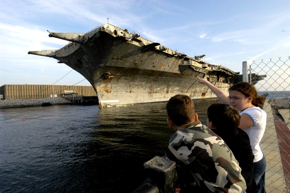 US Navy 050111-N-5328N-015 On lookers watch as the 888-foot decommission aircraft carrier Oriskany arrives in Pensacola on Dec. 20, 2004 from Corpus Christi, Texas