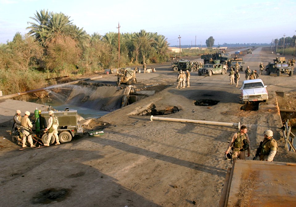 US Navy 041113-B-1250B-001 Sailors and Marines assigned to the 24th Marine Expeditionary Unit (24th MEU) survey the remnants of a bridge in Lutafiyah, Iraq