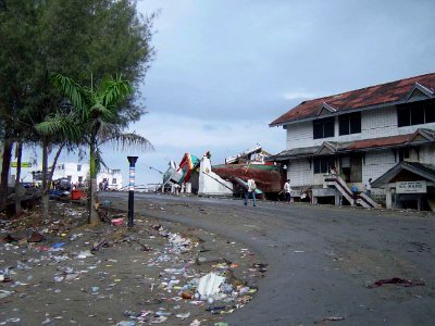 US Navy 050101-O-XXXXB-063 Boats washed ashore near local businesses in down town Aceh, Sumatra following a massive Tsunami that struck the area on the 26th of December 2004 photo