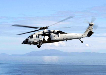 US Navy 050118-N-4336M-018 An MH-60S Knighthawk assigned Helicopter Combat Support Squadron Five (HC-5) returns to the Military Sealift Command (MSC) combat stores ship USNS Niagara Falls (T-AFS 3)