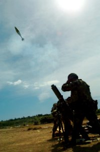 US Navy 041118-N-1464F-006 Sgt. Zody Mohammed (front), Spc. Greg Williams, Squad Leader, and Staff Sgt. Joaquin Rodriguez, fire a mortar round during live fire training at Hicacal Range