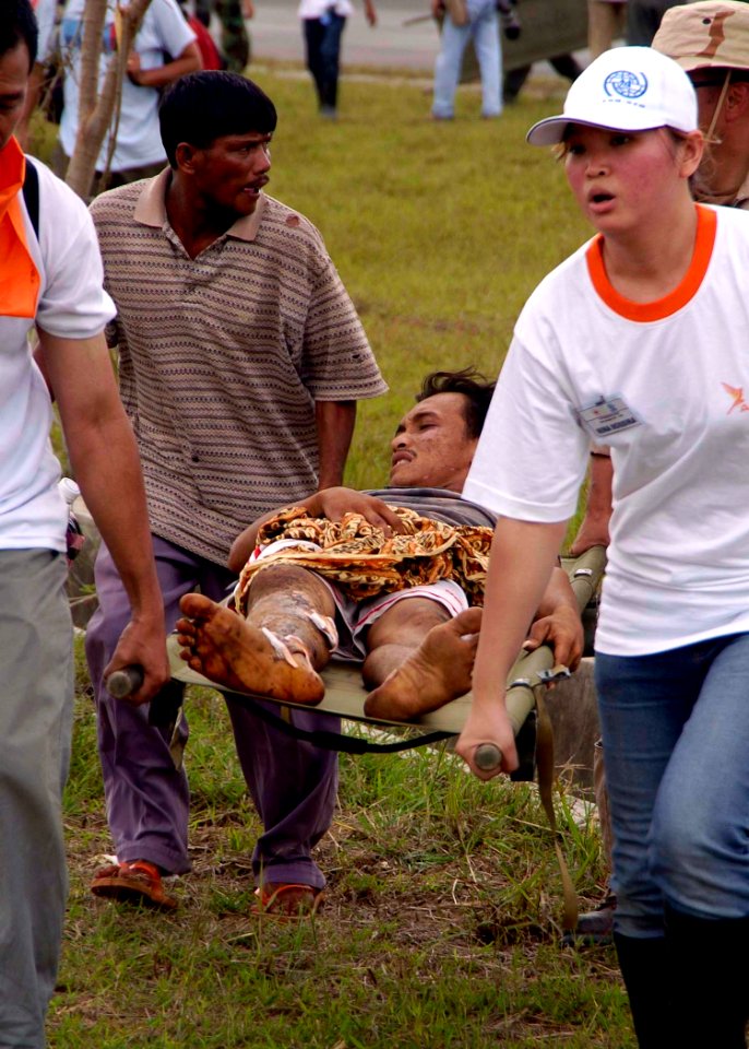 US Navy 050103-N-0057P-490 Aide workers rush a Tsunami victim to the U.S. Medical tent for treatment