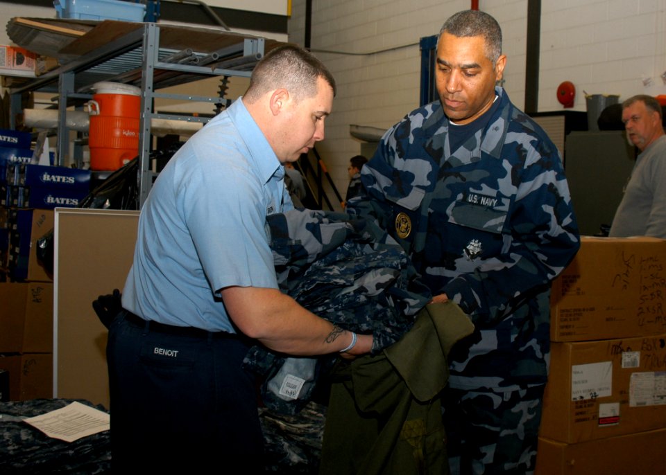US Navy 050120-N-4707B-005 Ship's Serviceman 1st Class Jimmie Summerhill assigned to the amphibious assault ship USS Iwo Jima (LHD 7) receives four prototype uniforms