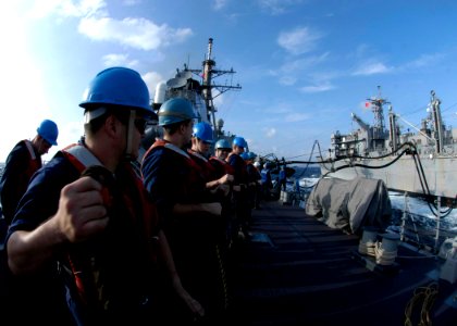 US Navy 050103-N-9079D-209 Sailors aboard the guided missile destroyer USS Benfold (DDG 65), hold lines during and underway replenishment with Military Sealift Command (MSC) fast combat support ship USNS Rainier (T-AOE 7)