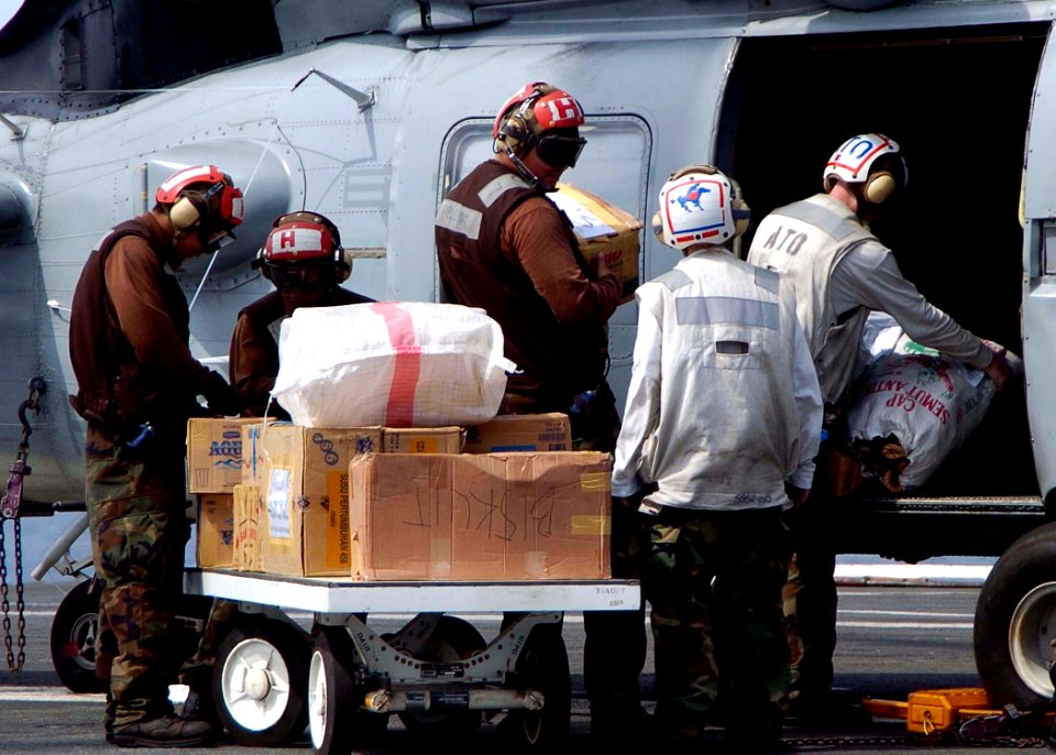 US Navy 050104-N-0057P-028 Boxes of water and food are loaded onto a SH-60B Seahawk helicopter