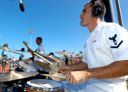 US Navy 050122-N-3019M-012 Musician 3rd Class Ross Hartig performs at the 2005 Hula Bowl All-Star game in Kahului, Maui. Eight members of the Pacific Fleet Rock Band represented the Navy at the game
