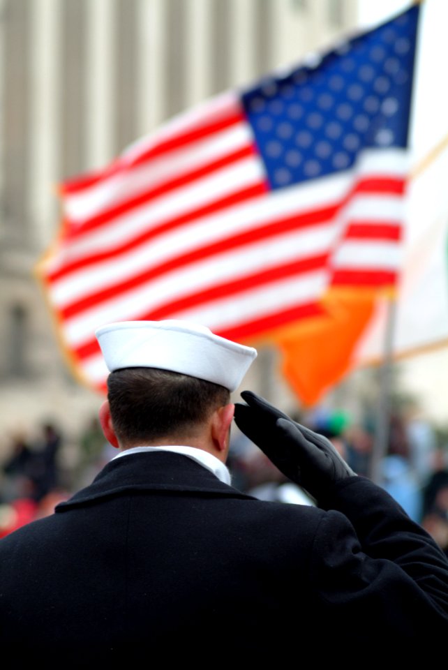 US Navy 050120-N-0962S-140 A Sailor lining the street cordon down Pennsylvania Avenue salutes the American flag as it passes during the Inauguration Day Parade held in Washington, D.C