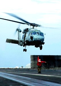 US Navy 050104-N-6074Y-016 A Landing Signals Enlisted (LSE) Sailor launches a SH-60F Seahawk helicopter off the flight deck of USS Abraham Lincoln (CVN 72) en route to Aceh, Sumatra, Indonesia carrying relief supplies
