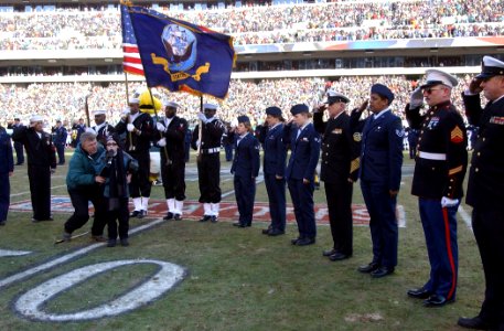US Navy 050123-N-4729H-062 Marines, Sailors and Airmen assigned to Philadelphia, Pa., area bases, salute during the National Anthem prior to the start of the National Football League National Football Conference championship ga