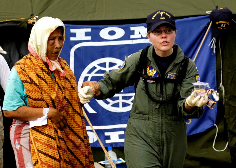 US Navy 050103-N-4166B-237 Lt. Jody Weinstein helps an injured Indonesian woman into a medical evacuation vehicle after she was transported from a coastal village on the island of Sumatra, Indonesia