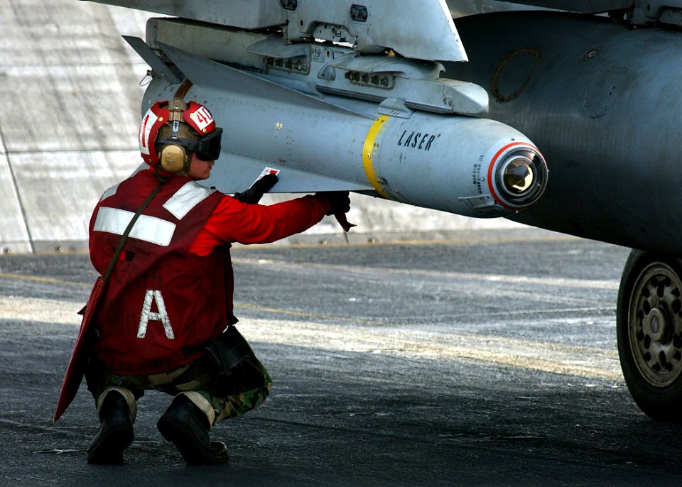 US Navy 041128-N-5345W-016 Aviation Ordnanceman 3rd Class William Miller arms an AGM-65 Maverick laser-guided missile