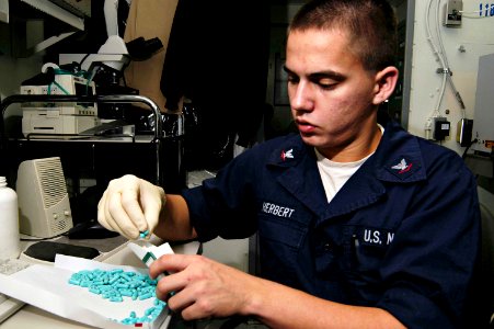US Navy 050101-N-4166B-041 Hospital Corpsman 3rd Class Kevin Herbert packs Doxycycline, a Malaria medication photo