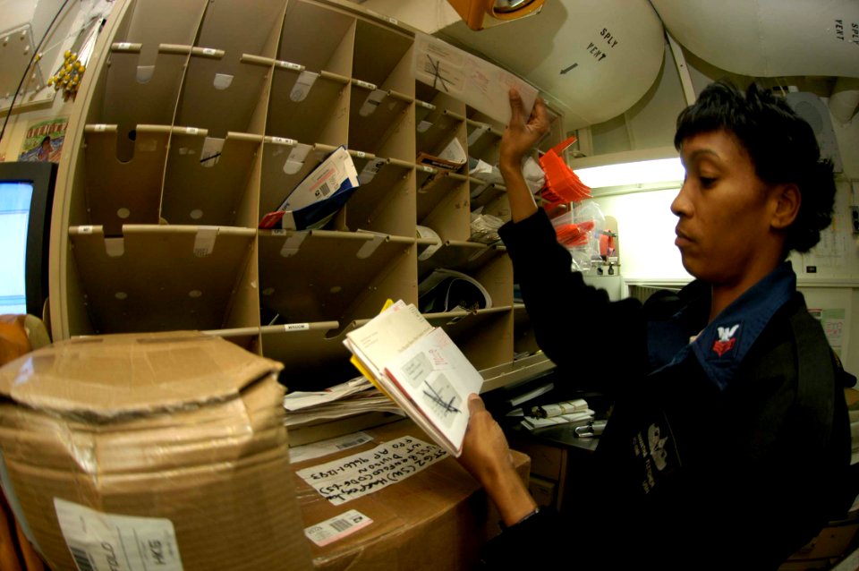 US Navy 050103-N-9079D-039 Postal Clerk 1st Class Samantha Fletcher of Youngstown, Ohio, sorts mail aboard the guided missile destroyer USS Benfold (DDG 65)