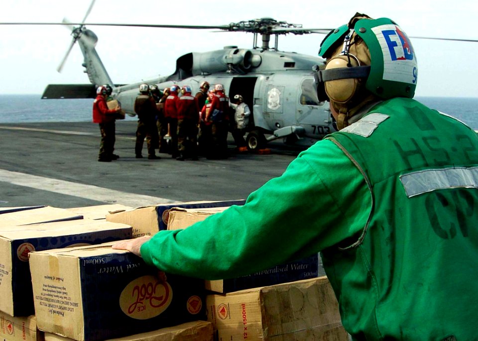 US Navy 050104-N-0057P-032 Boxes of bottled water wait on the flight deck aboard USS Abraham Lincoln (CVN 72) to be loaded onto a SH-60B Seahawk helicopter