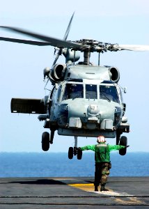 US Navy 050105-N-4166B-086 An SH-60B Seahawk helicopter lands on the flight deck aboard USS Abraham Lincoln (CVN 72) to pick up jugs of purified water