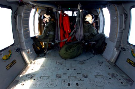 US Navy 050123-N-2653P-250 Air crewman fly back to their ship in an MH-60S Knighthawk helicopter after another successful humanitarian aid mission to the island of Sumatra, Indonesia