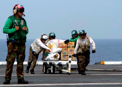 US Navy 050104-N-0057P-006 Boxes of water and food are staged aboard USS Abraham Lincoln (CVN 72) prior to being loaded onto SH-60B Seahawk helicopter