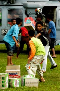 US Navy 050106-N-4166B-439 Indonesian children in Lamno, Sumatra, Indonesia, work together to unload relief supplies