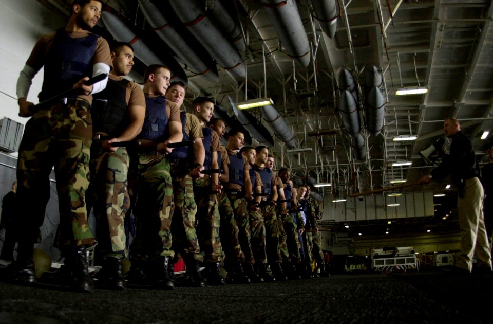 US Navy 050125-N-2143T-097 Legal Department conducts riot control drill during force protection training in the hanger bay aboard USS Nimitz (CVN 68)